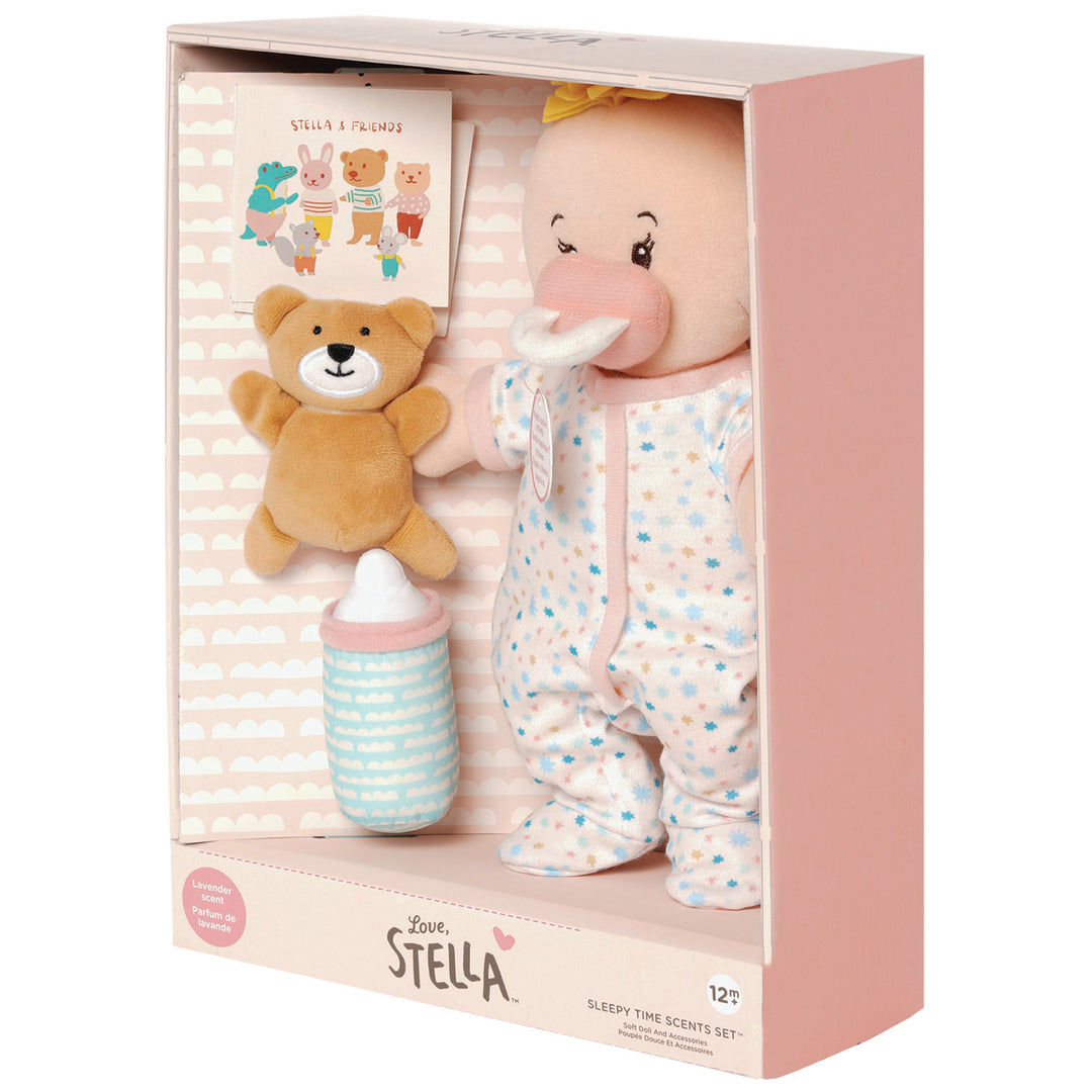 soft baby doll with peach skin tone that is lavender scented and comes with a soft bear mini book and soft bottle for pretend play pictured in open front box package
