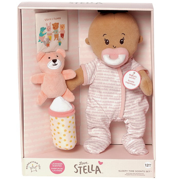 soft baby doll with beige skin tone that is lavender scented and comes with a soft bear mini book and soft bottle for pretend play pictured in open front box package