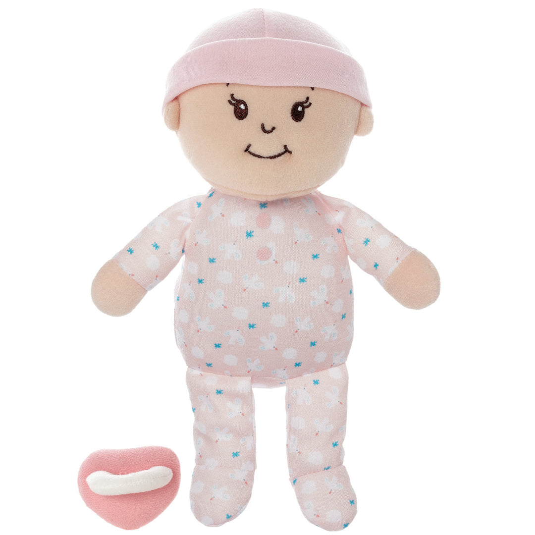 soft baby snuggle doll with peach skin that includes a magnetic pacifier and removable pink beanie hat