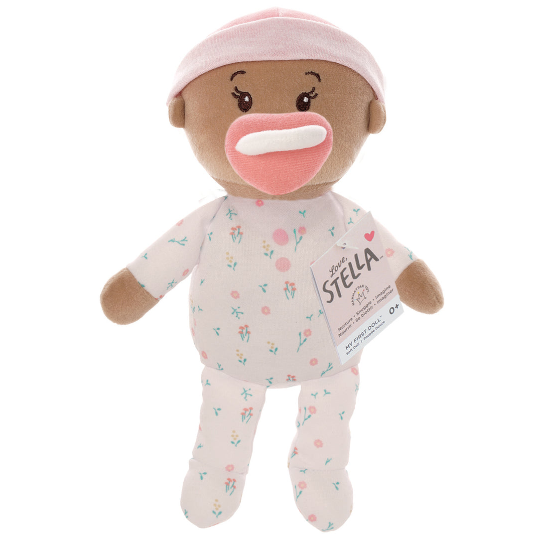 soft baby snuggle doll with beige skin that includes a magnetic pacifier and removable pink beanie hat with hangtag packaging