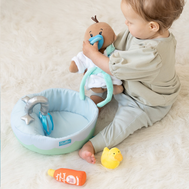 little girl playing with soft doll 