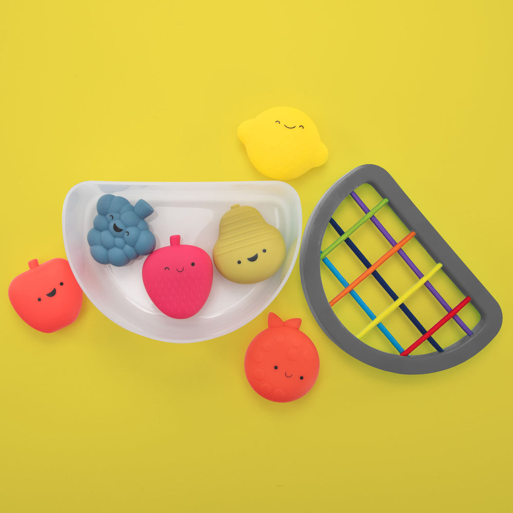 fruit fill n' spill toy overhead on a yellow background