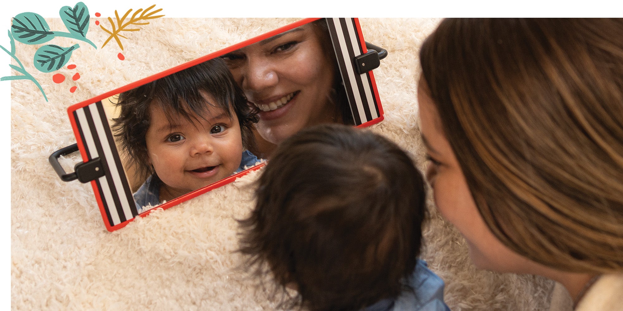 Mom and baby smiling at their reflection in a tummy time mirror