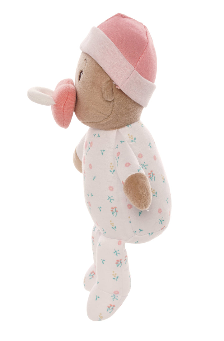 soft baby snuggle doll with beige skin and brown hair that includes a magnetic pacifier 